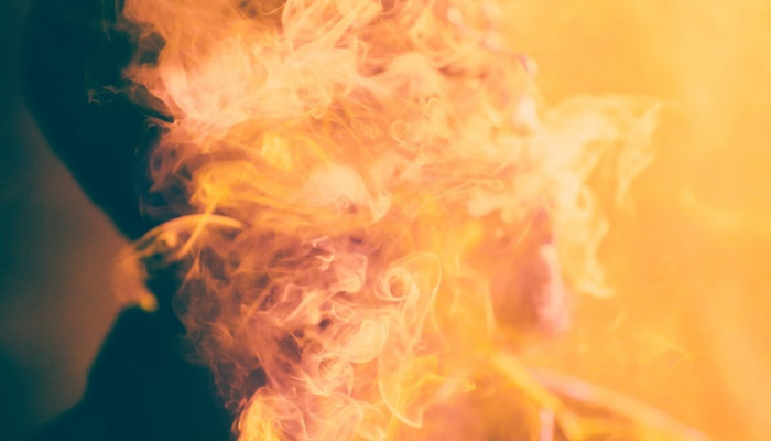 macro photography of man covered by cigar smoke