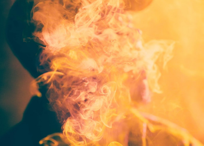 macro photography of man covered by cigar smoke