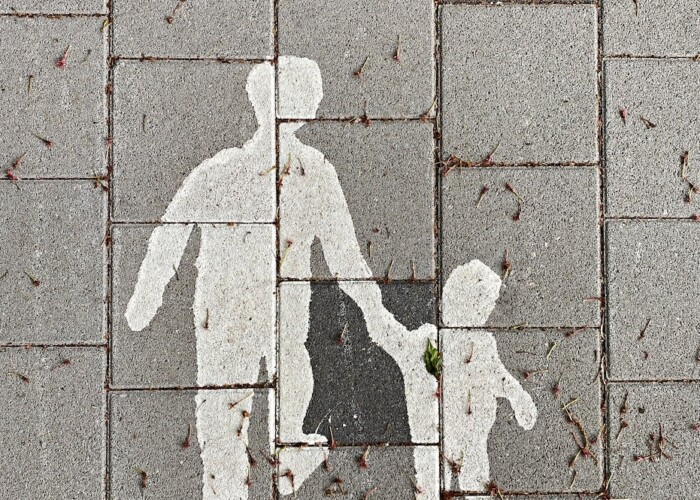 2 person walking on gray concrete pavement