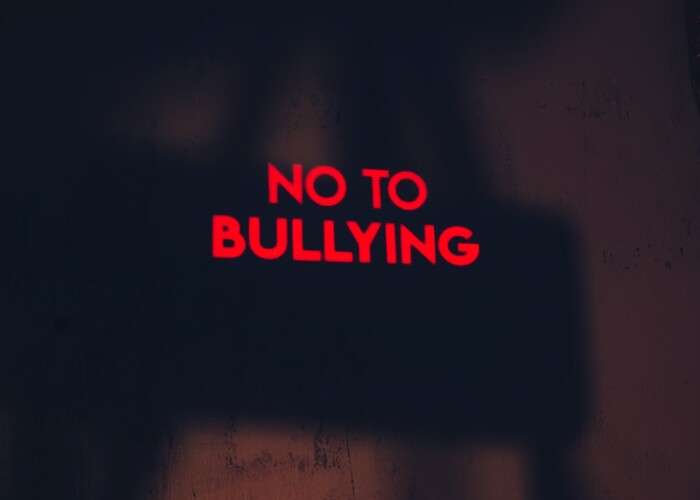 a red sign that says no to bullying